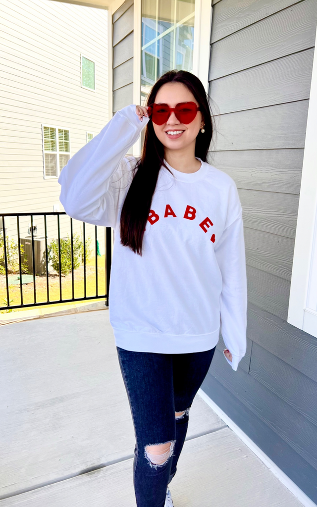 White sweatshirt with red Babe lettering 